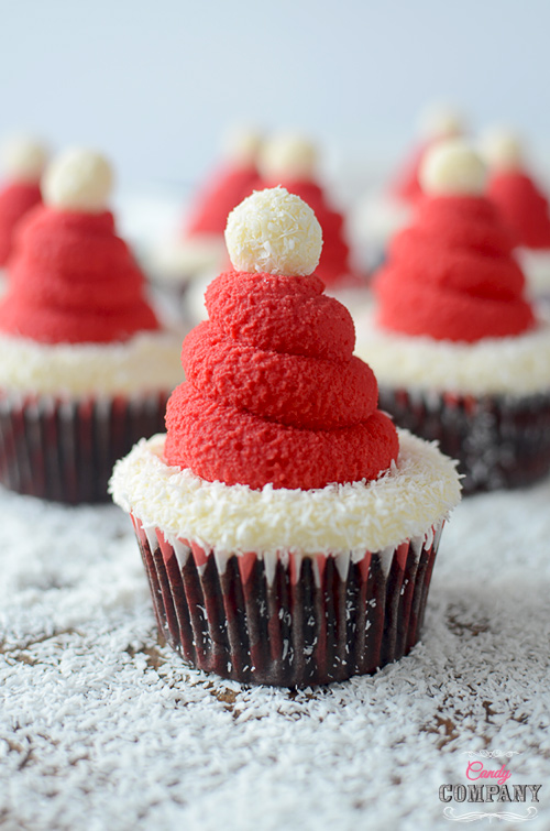 Santa Hat cupcakes. Moist chocolate cupcake with coconut filling and coconut flavored whipped cream.