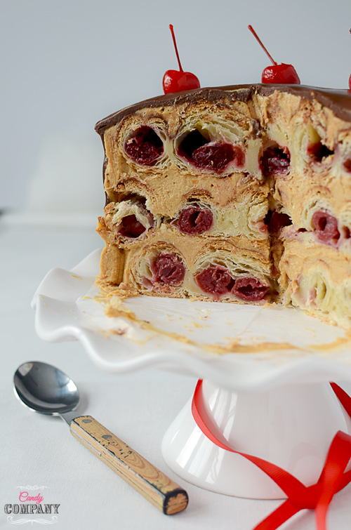 Honeycomb cake made from puff pastry with cherries and dulche de leche frosting and chocolate glaze