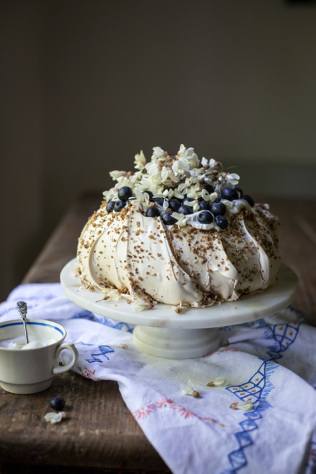 hazelnut praline, blueberry and false acacia tree flower pavlova recipe. Food photography by Candy Company